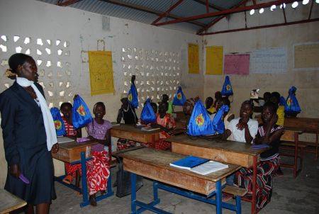 The TBI mobile clinic Nurse, Beatrice, with the students displaying their kits to thank the donor The TBI mobile clinic Nurse, Beatrice, with the students displaying their kits to thank the donor